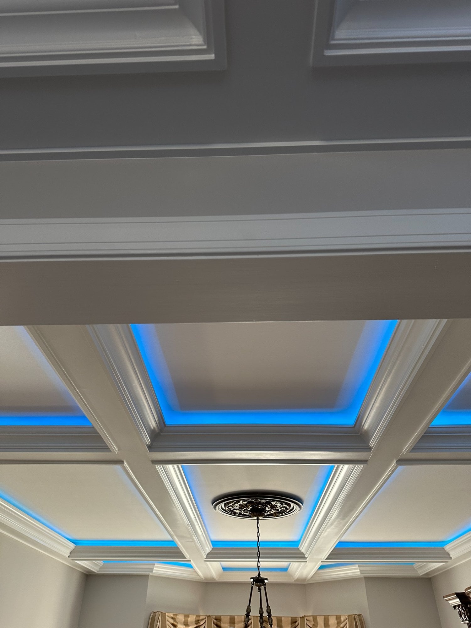 Coffered ceiling with crown molding and LED lighting