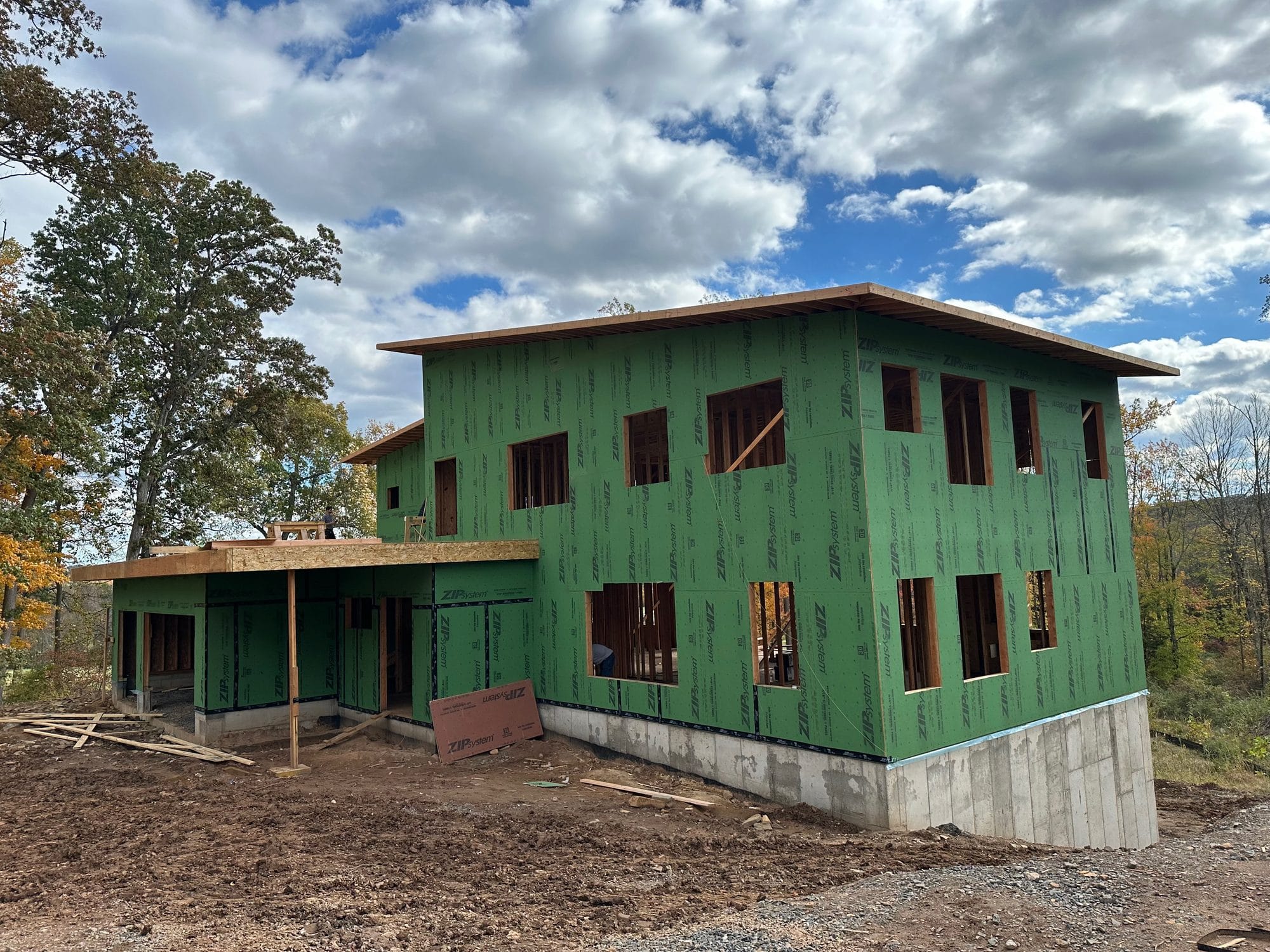 Monte Carlo home under construction wrapped in green ZIP System sheathing with every seam taped